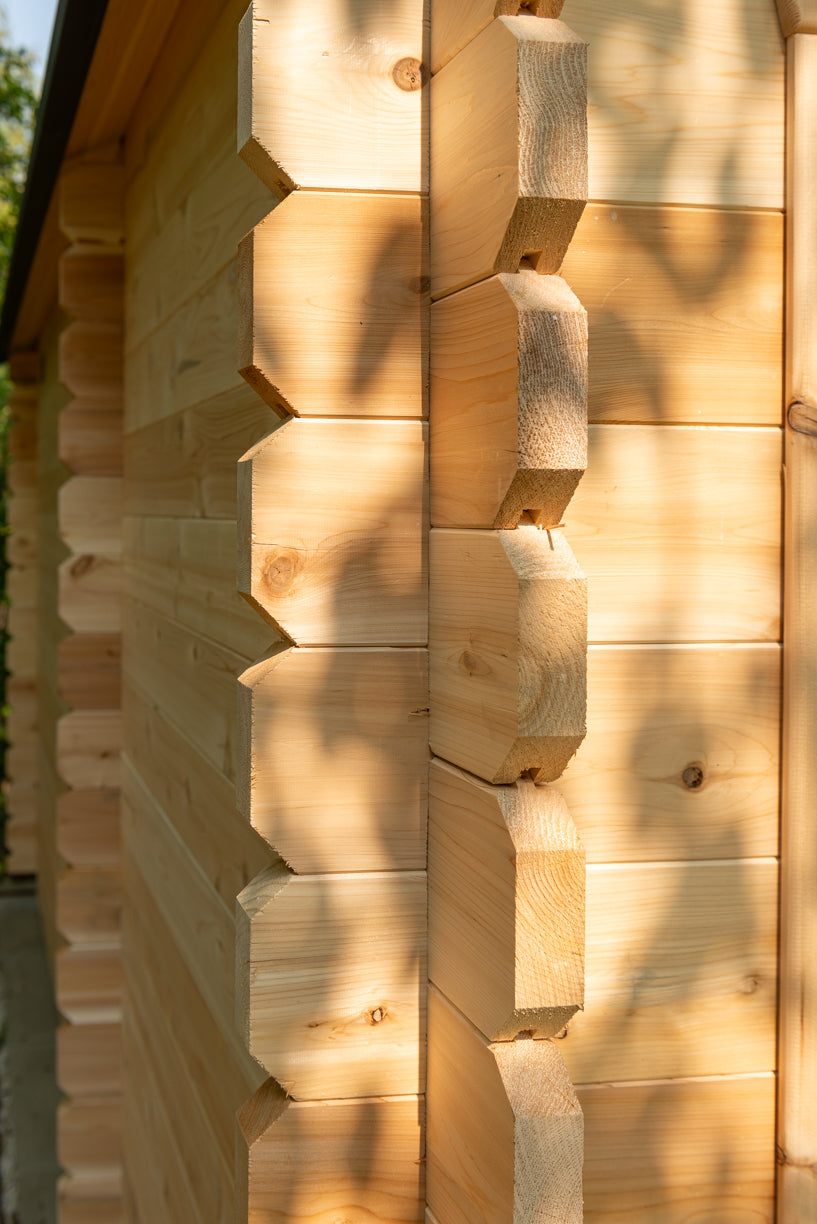 Close-up of a wooden cabin wall with hexagonal patterns
