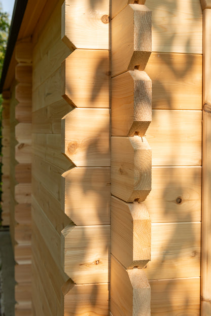 Close-up of a wooden cabin wall with hexagonal patterns