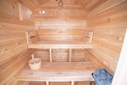 Wooden sauna with benches and a bucket