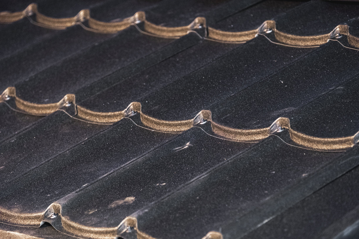 Close-up of a textured black roof surface with wavy pattern