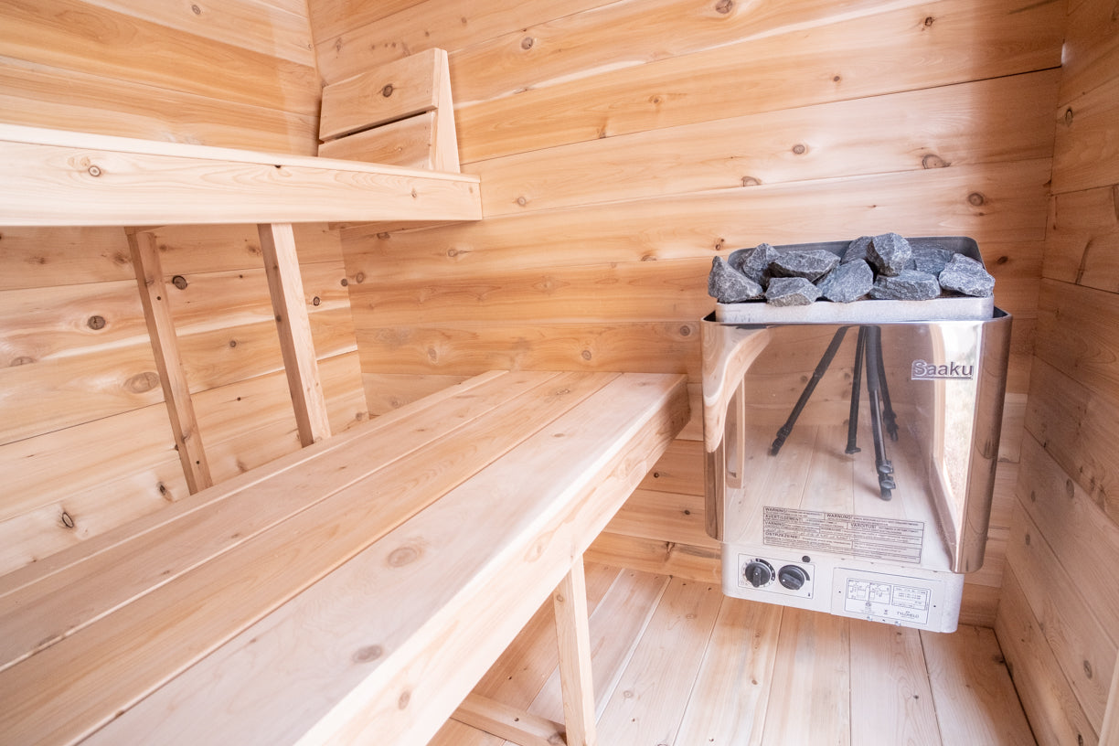 Wooden sauna interior with a bench and sauna heater.