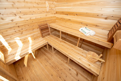 Wooden sauna interior with benches and a mat.