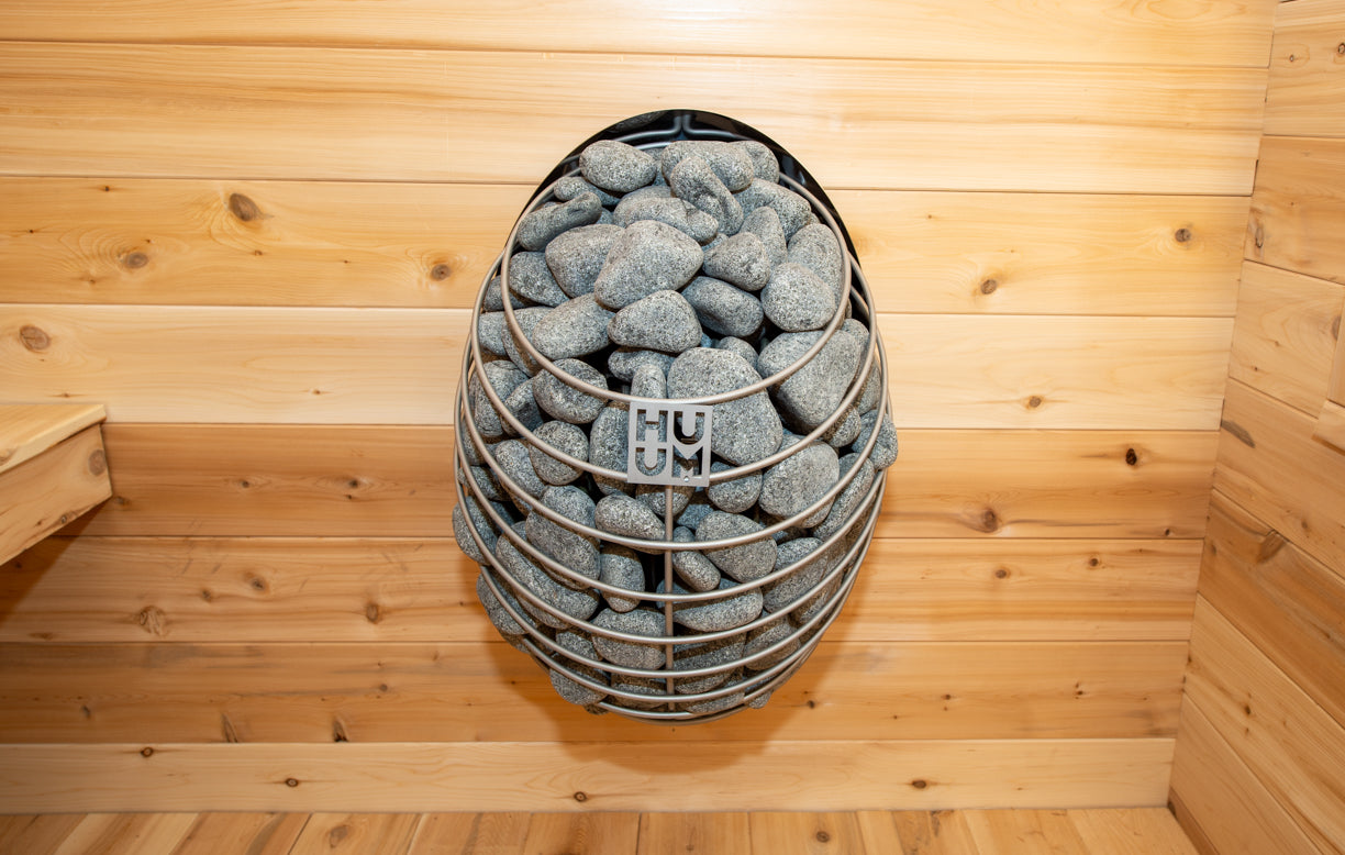 Huum Hive electric sauna heater inside a wooden sauna