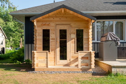 Wooden shed attached to a house with a clear sky background