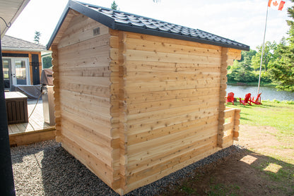Wooden cabin by a lake with a flag in the background