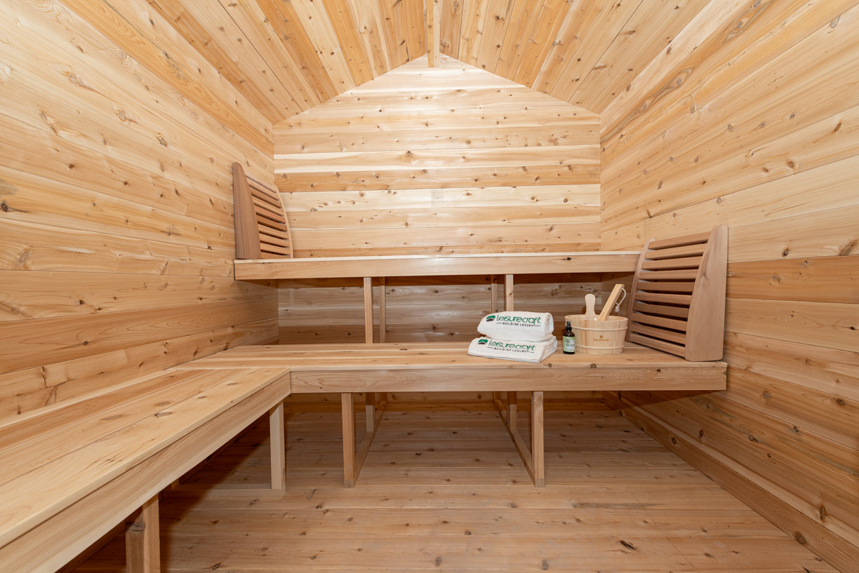 Wooden sauna interior with benches and a table.