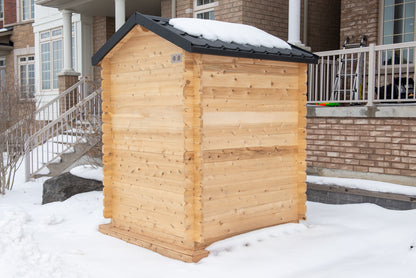 Wooden shed with snow on the roof in a residential area