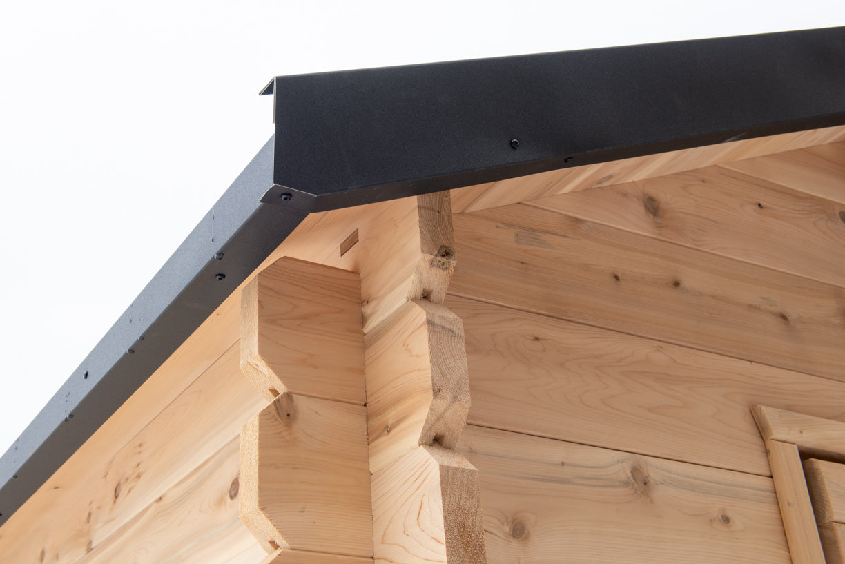 Wooden cabin roof with a metal flashing detail