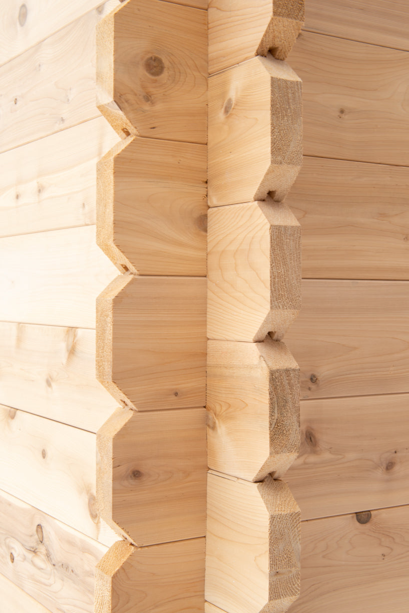 Close-up of a wooden wall with hexagonal log pattern