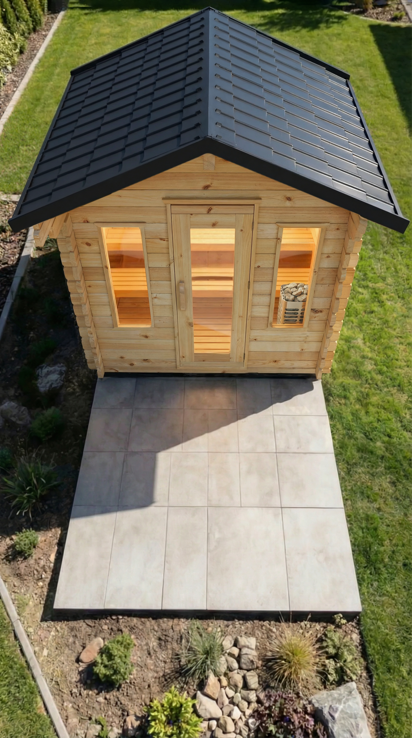 Wooden cabin with a black roof on a grassy area
