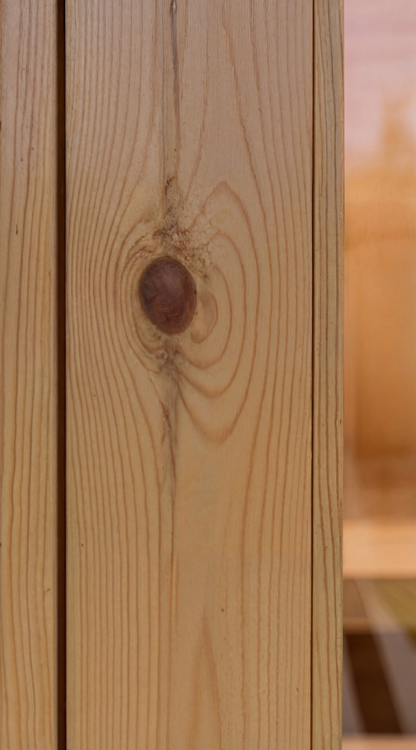 Close-up of a cedar wood surface with a prominent tight knot