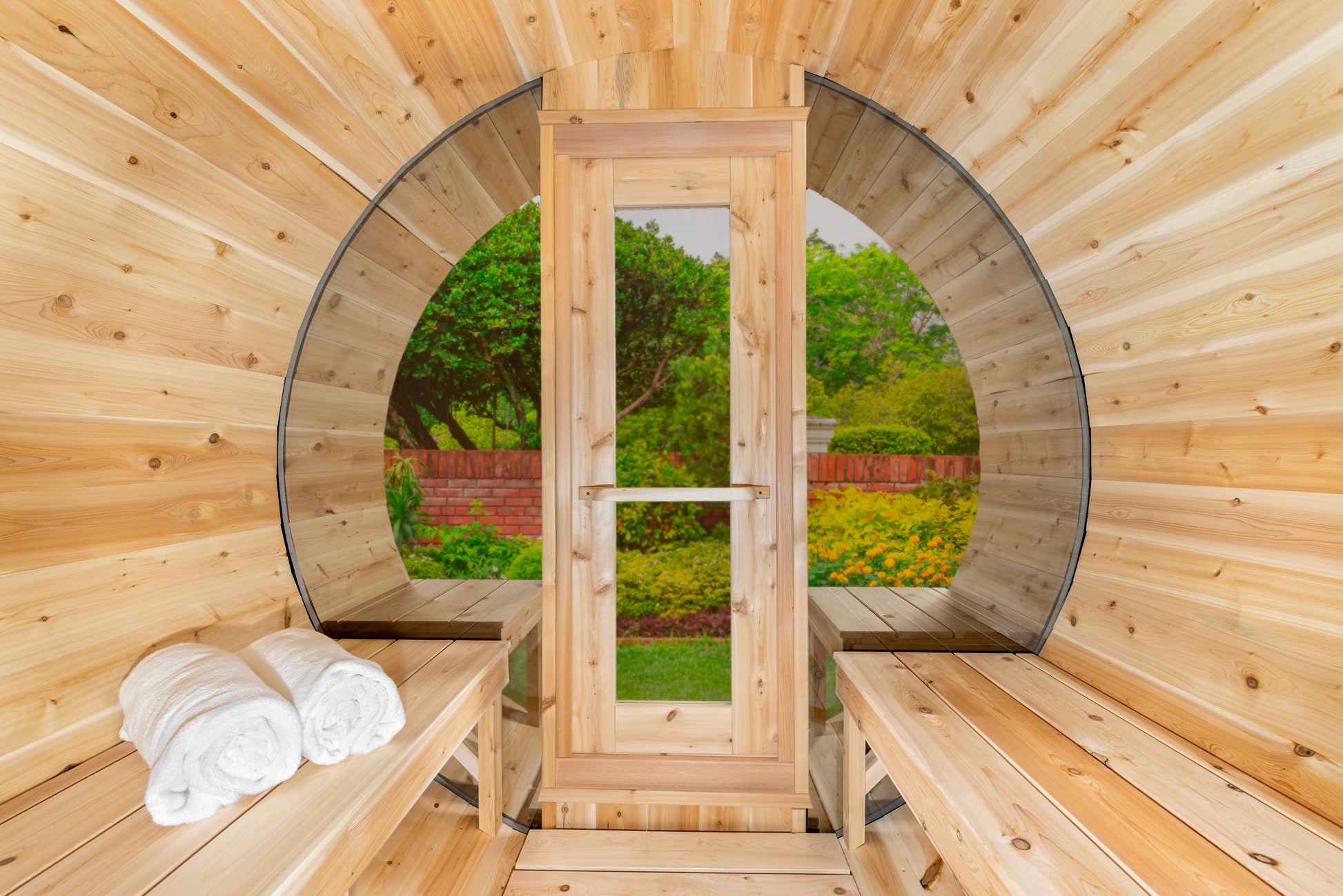 Wooden sauna with benches and towels, surrounded by nature