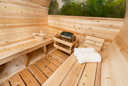 Wooden sauna with benches, towels, and a basket.