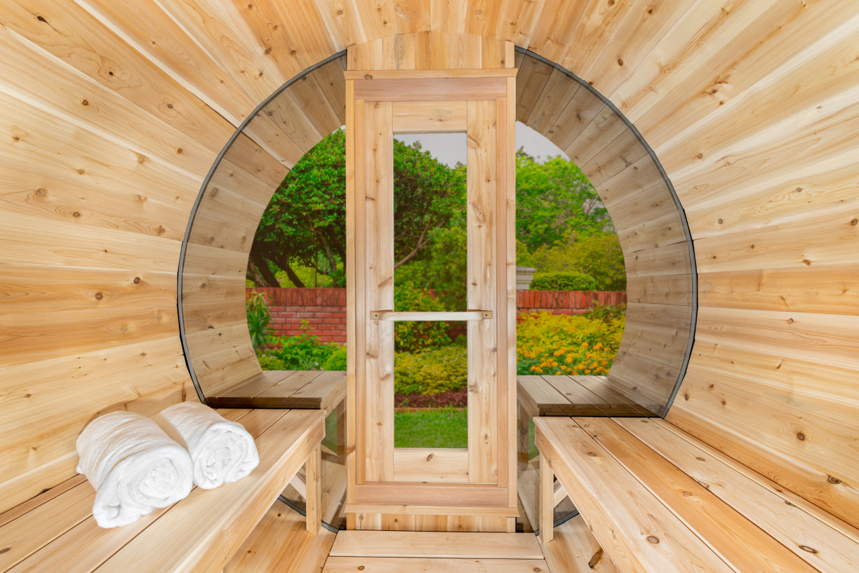 Wooden sauna with benches and towels, surrounded by nature