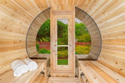 Wooden sauna with benches and towels, surrounded by nature