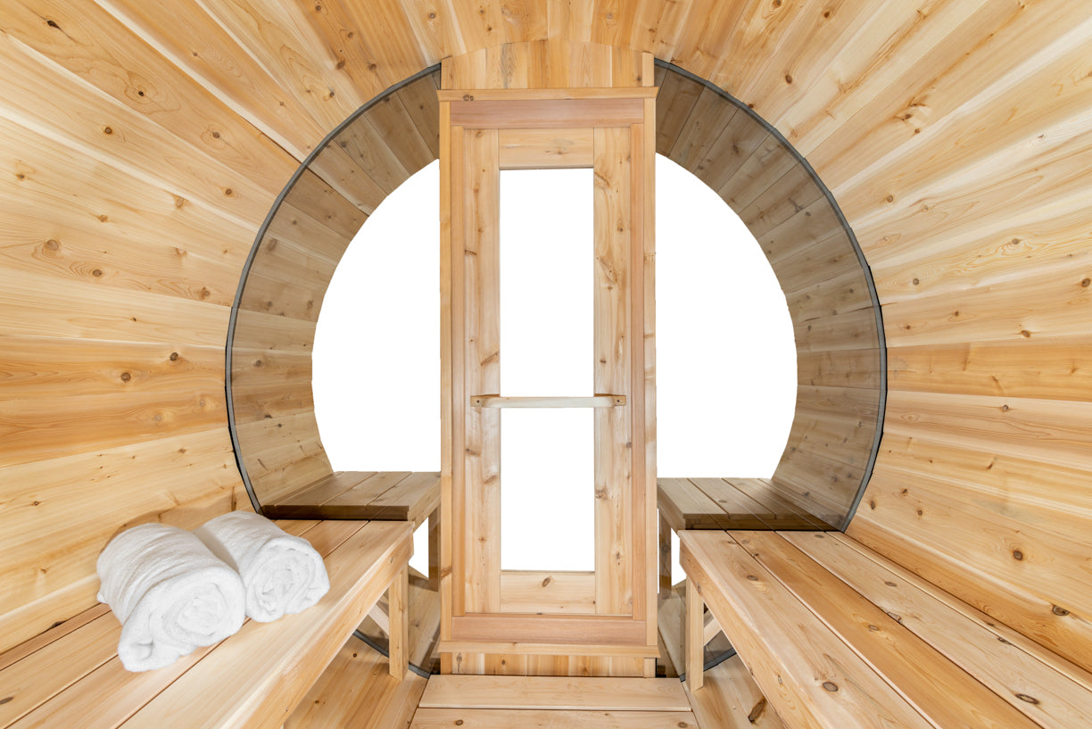 Wooden sauna interior with benches and towels