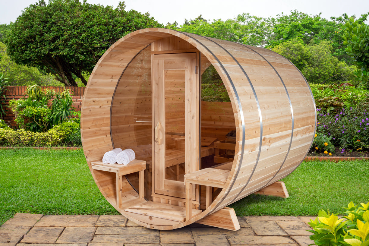Wooden barrel-shaped outdoor sauna in a garden setting